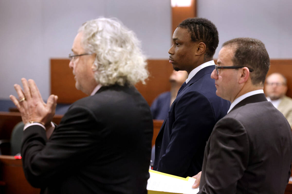 Former Raiders player Henry Ruggs, center, appears in court with his attorneys, David Chesnoff, ...