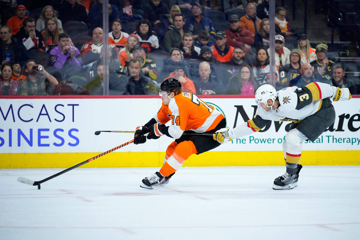 Philadelphia Flyers' Owen Tippett, left, tries to get past Vegas Golden Knights' Brayden McNabb ...