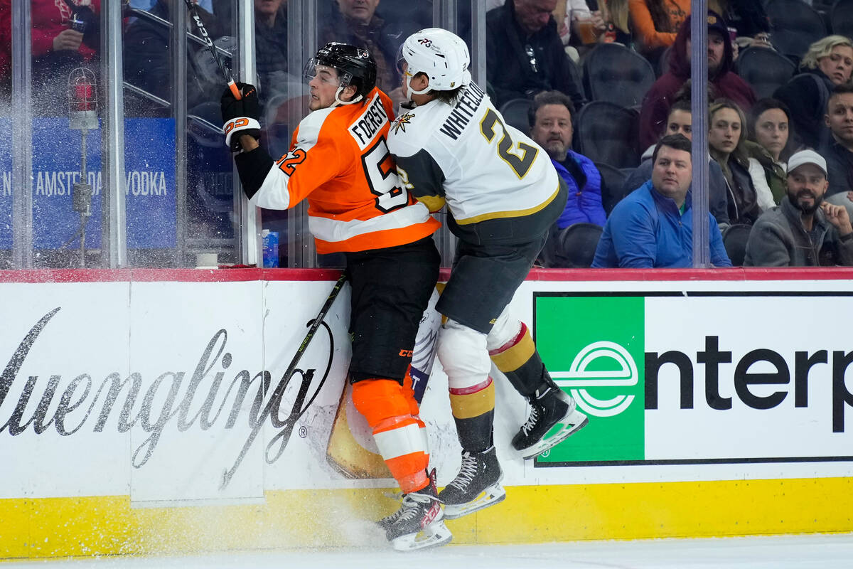 Vegas Golden Knights' Zach Whitecloud, right, collides with Philadelphia Flyers' Tyson Foerster ...