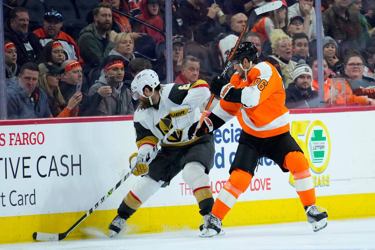 Vegas Golden Knights' Phil Kessel, left, and Philadelphia Flyers' Joel Farabee battle for the p ...