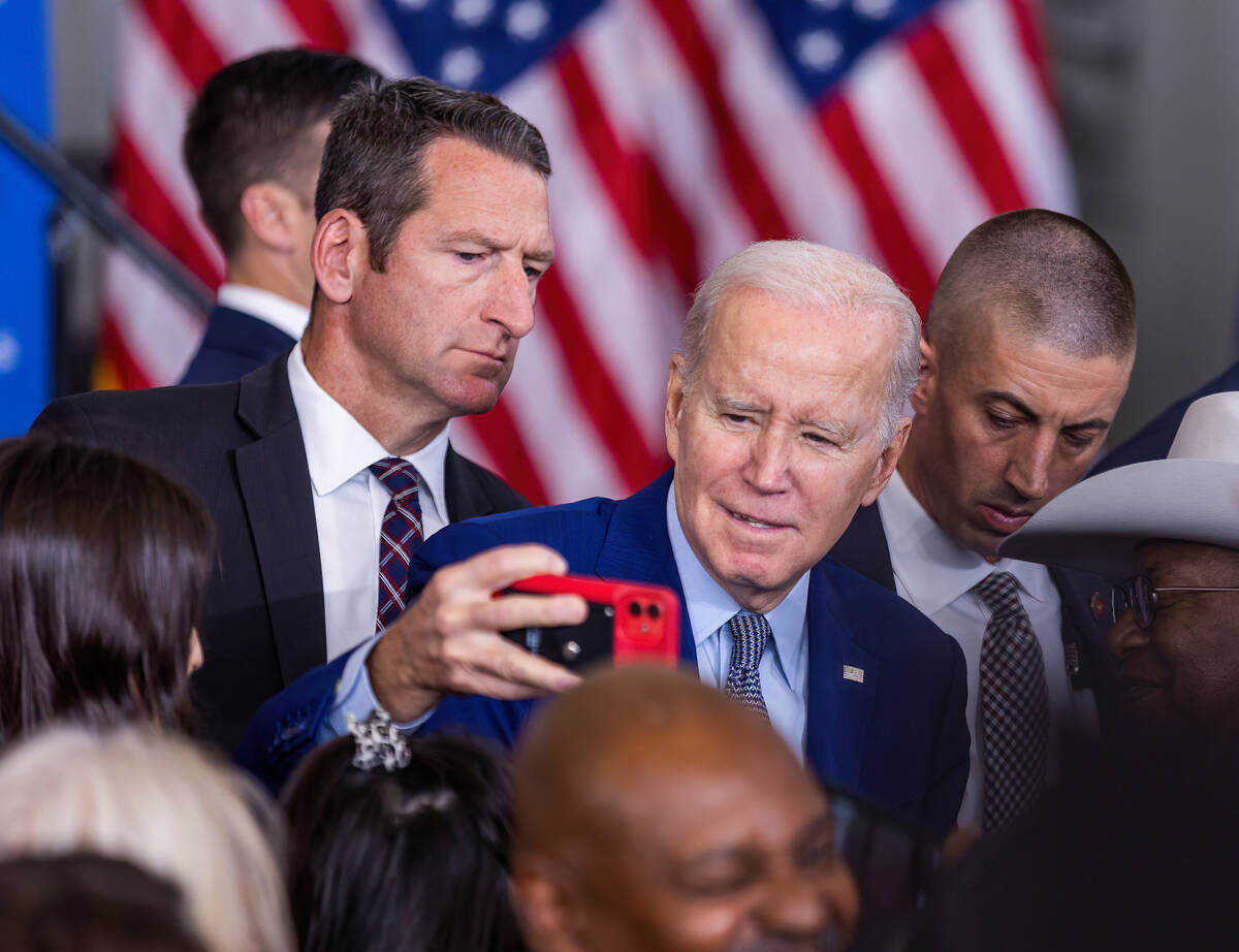 President Joe Biden takes a selfie with an attendee after talking about lowering prescription d ...