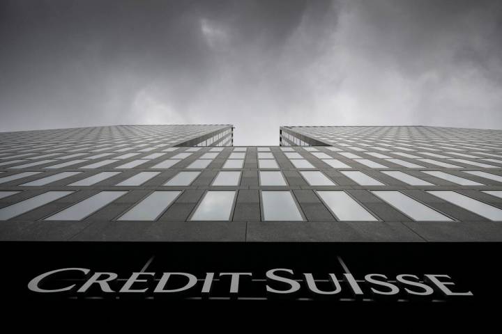FILE - Grey clouds cover the sky over a building of the Credit Suisse bank in Zurich, Switzerla ...