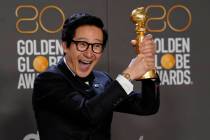 Ke Huy Quan poses in the press room with the award for best performance by an actor in a suppor ...