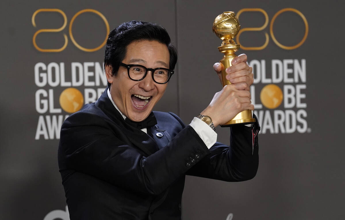 Ke Huy Quan poses in the press room with the award for best performance by an actor in a suppor ...