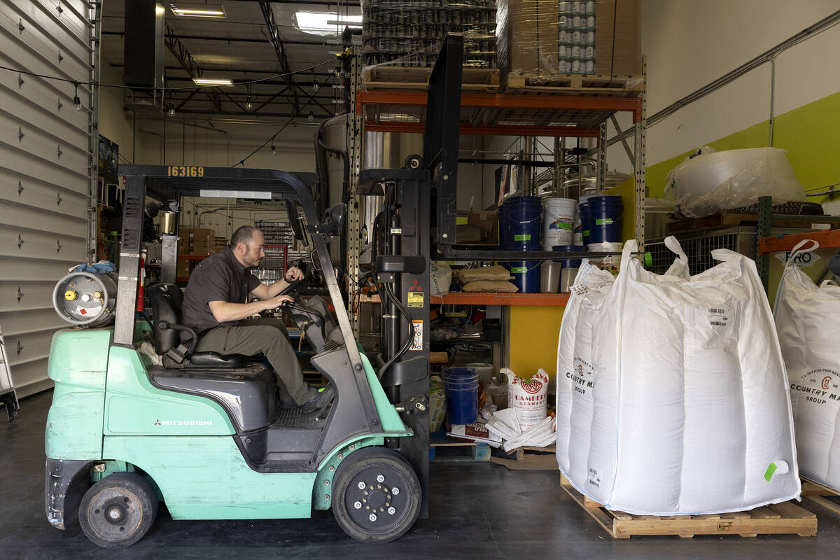 Head brewer Cameron Fisher uses a forklift to elevate grain at CraftHaus Brewery on Wednesday, ...