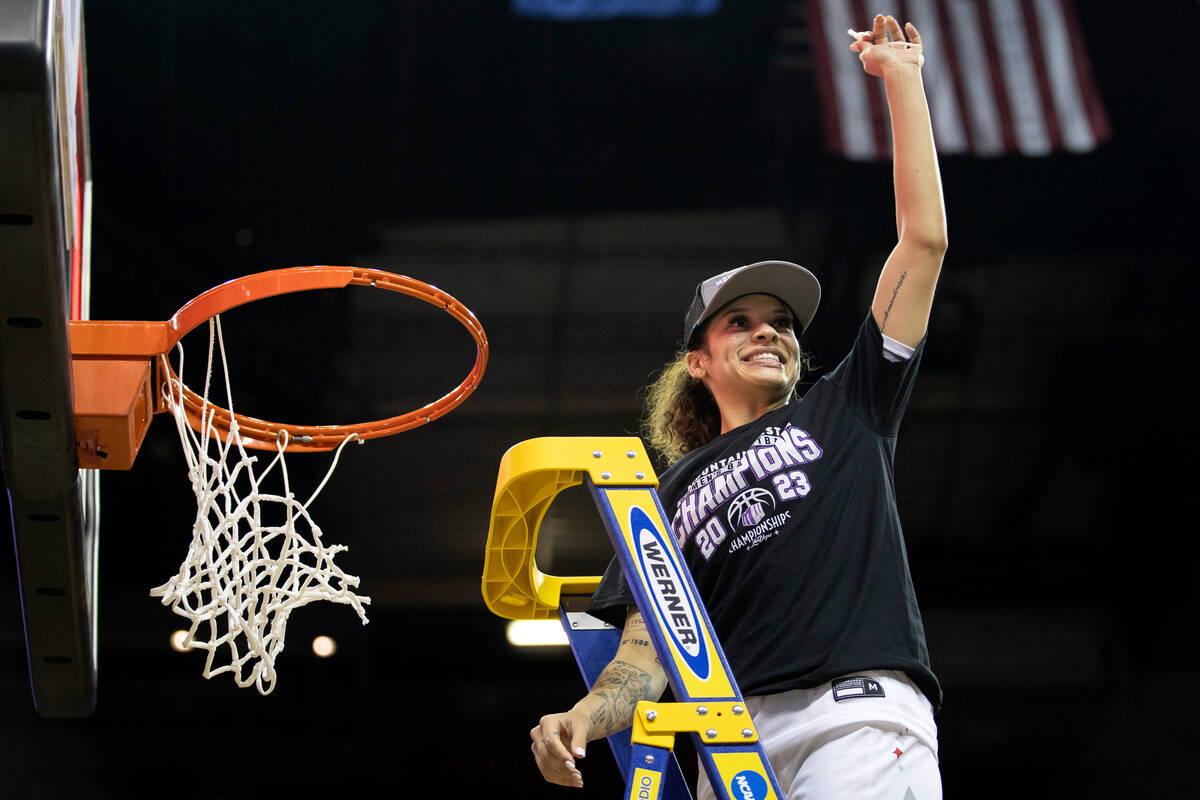 UNLV Lady Rebels guard Essence Booker holds up her piece of net after the Lady Rebels won the M ...
