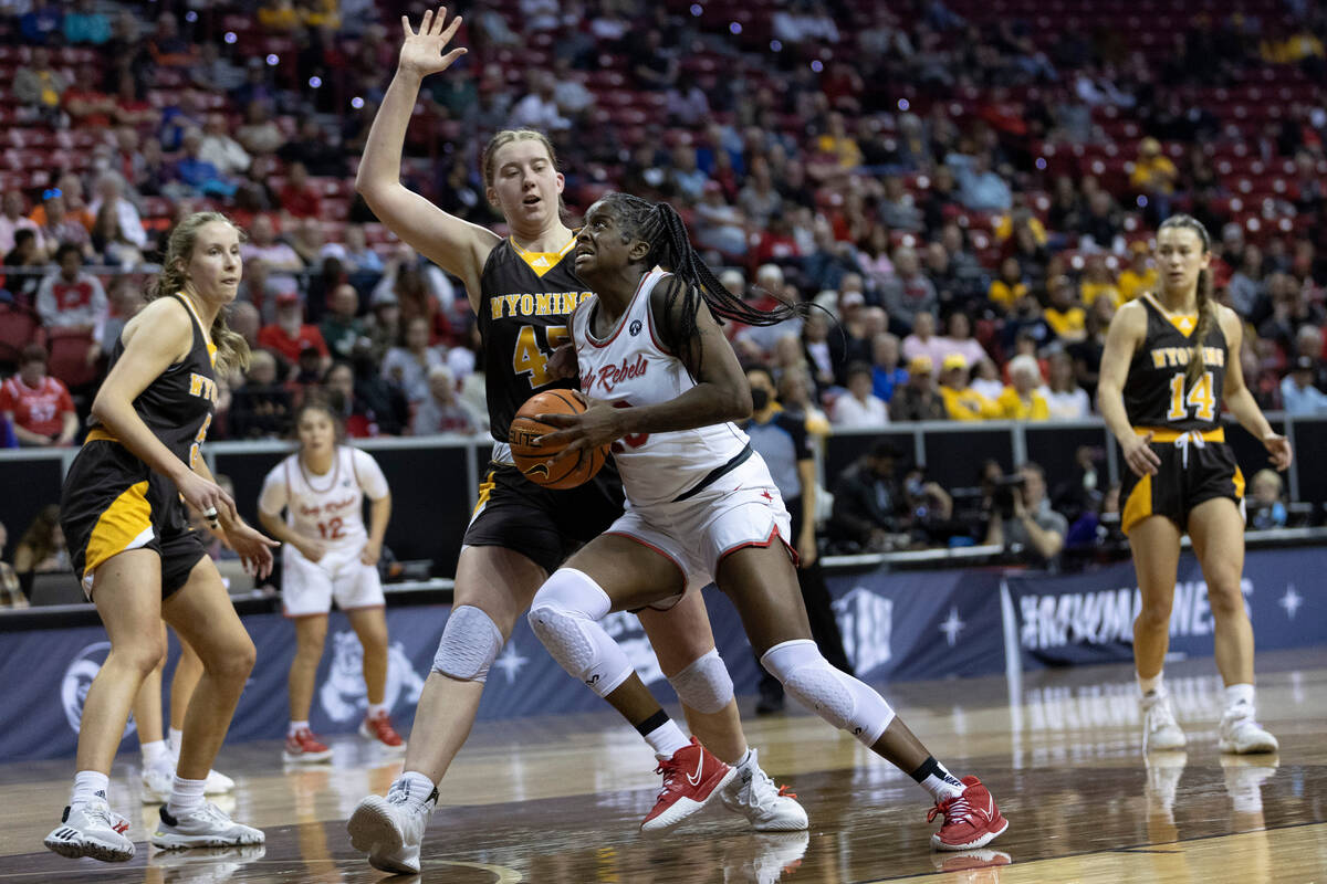 UNLV Lady Rebels center Desi-Rae Young (23) drives toward the hoop against Wyoming Cowgirls cen ...