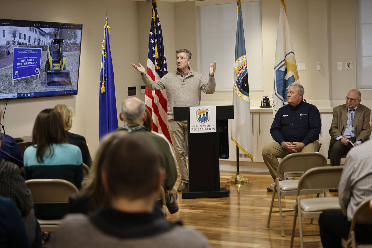 JC Davis of Southern Nevada Water Authority, left, speaks during a groundbreaking on a xeriscap ...