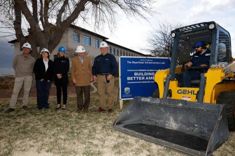 Joel Dunbar of the Bureau of Reclamation, right, operates a skid steer to remove the grass as t ...