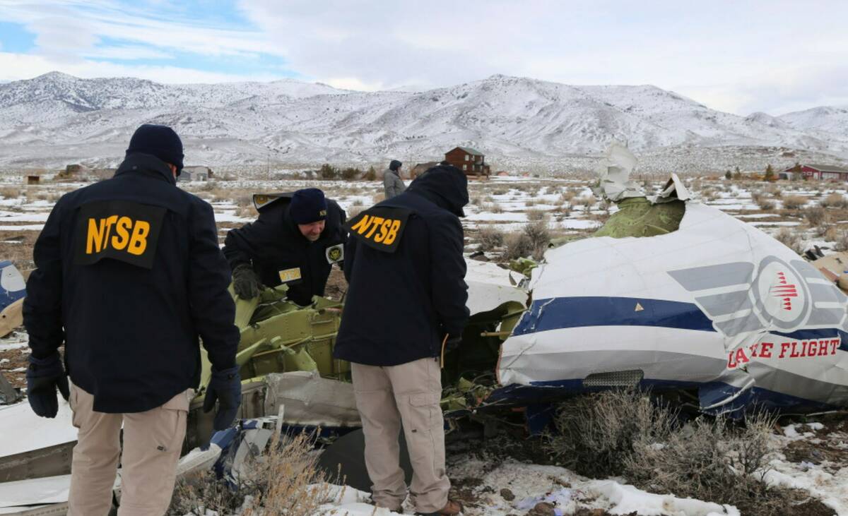 NTSB investigators document the wreckage of a Pilatus PC-12 airplane, a medical air transport f ...