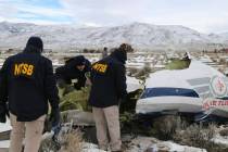 NTSB investigators document the wreckage of a Pilatus PC-12 airplane, a medical air transport f ...