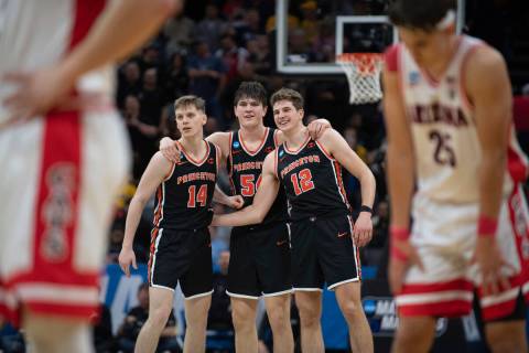 Princeton guard Matt Allocco (14) forward Zach Martini (54) and forward Caden Pierce (12) and t ...