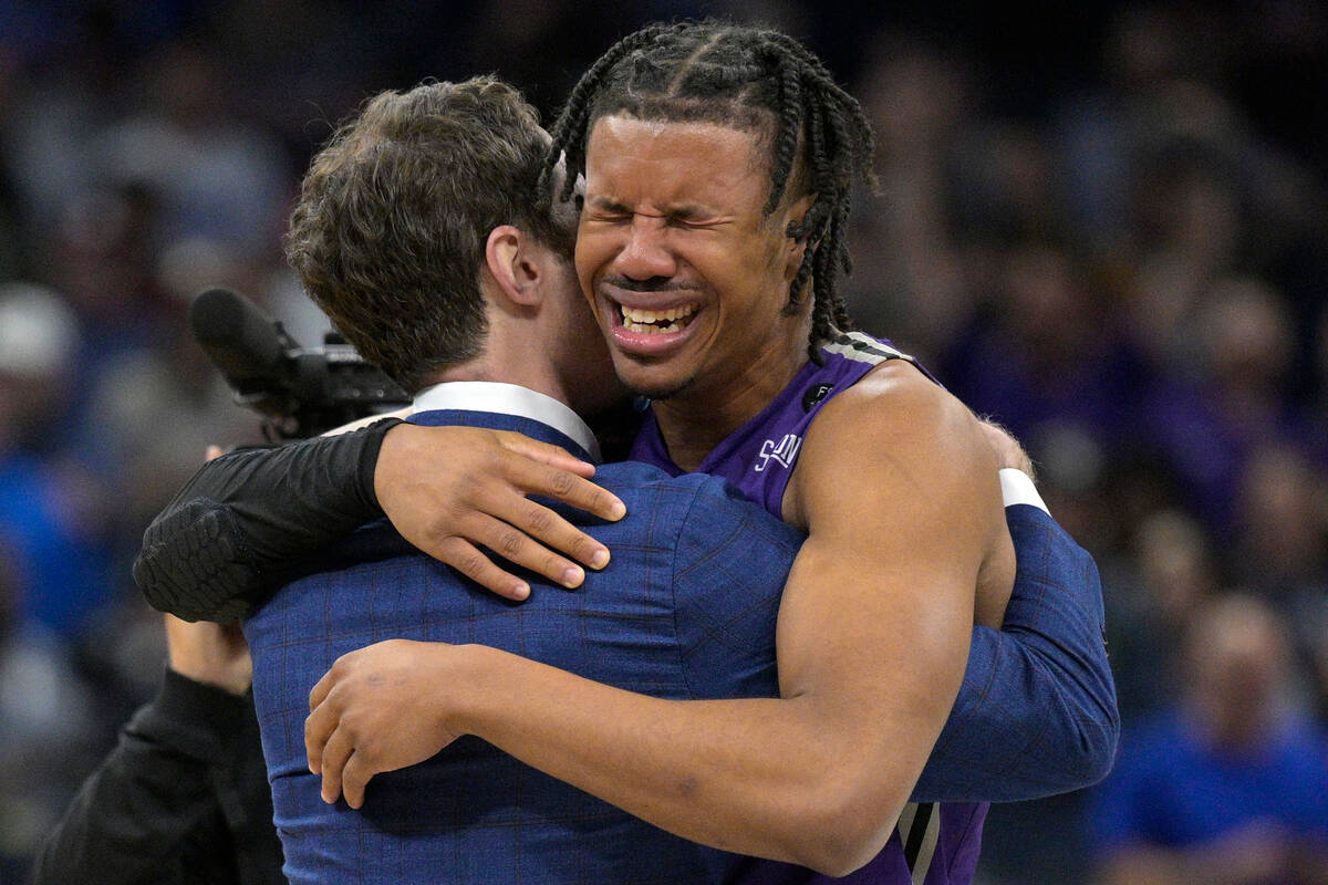 Furman guard Mike Bothwell, right, gets emotional after their win against Virginia during the s ...