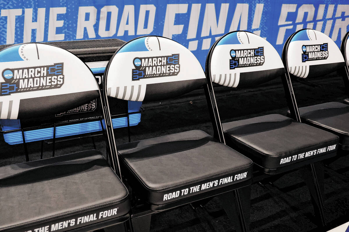 March Madness logos adorn seats at a first-round college basketball game in the NCAA Tournament ...