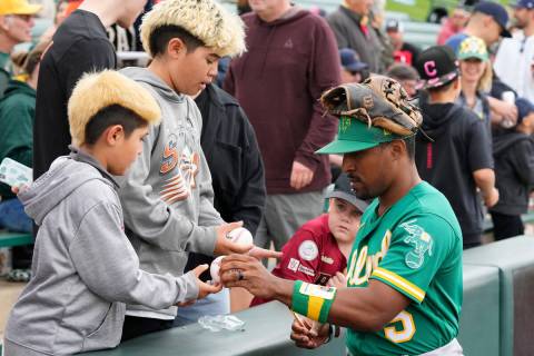 Oakland Athletics' Tony Kemp signs autographs for fans prior to a spring training baseball game ...