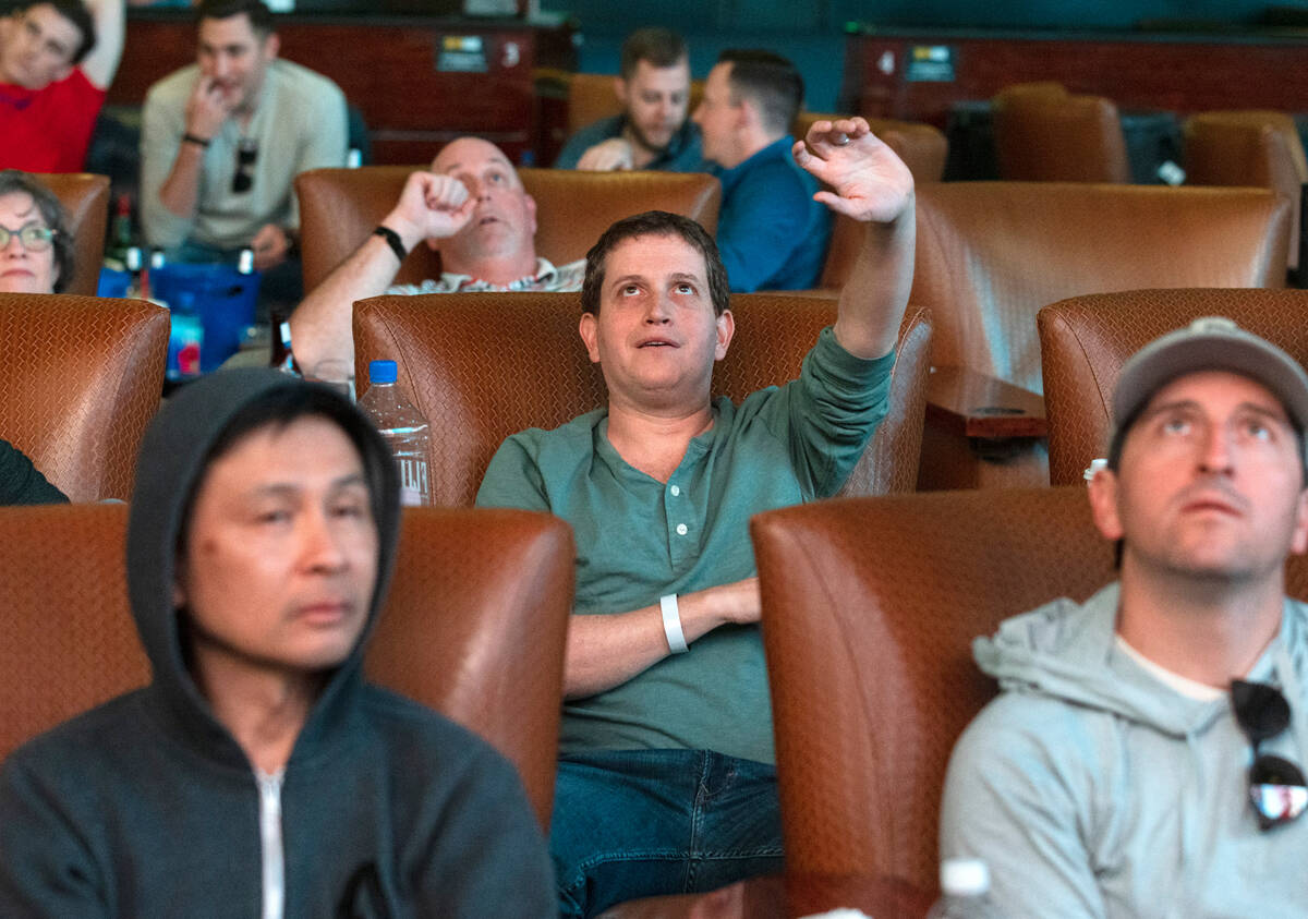 Guests watch on the big screens during the first day of the NCAA basketball tournament at the W ...