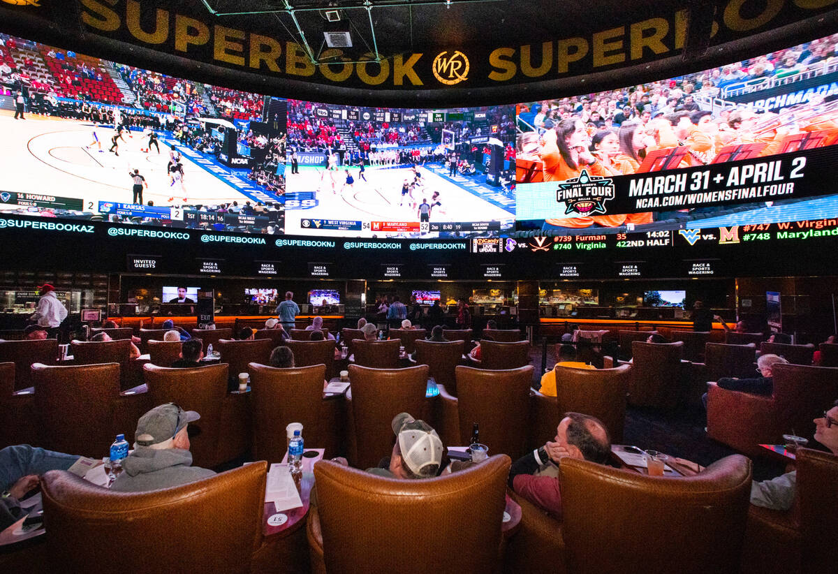 Guests watch on the big screens the first day of the NCAA basketball tournament at the Westgate ...