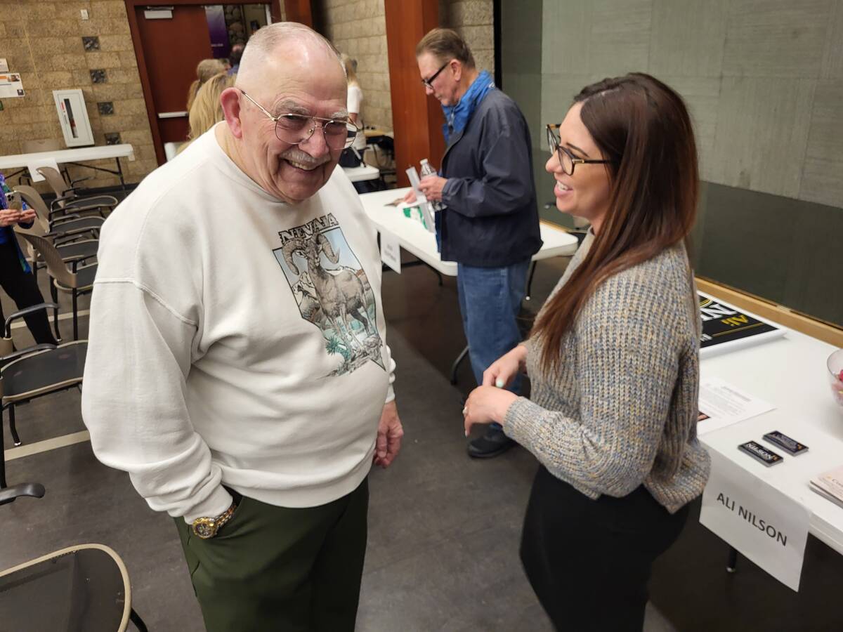 Chuck Booker (left) talking to Ali Nilson (right). (Mark Credico/Las Vegas Review-Journal)