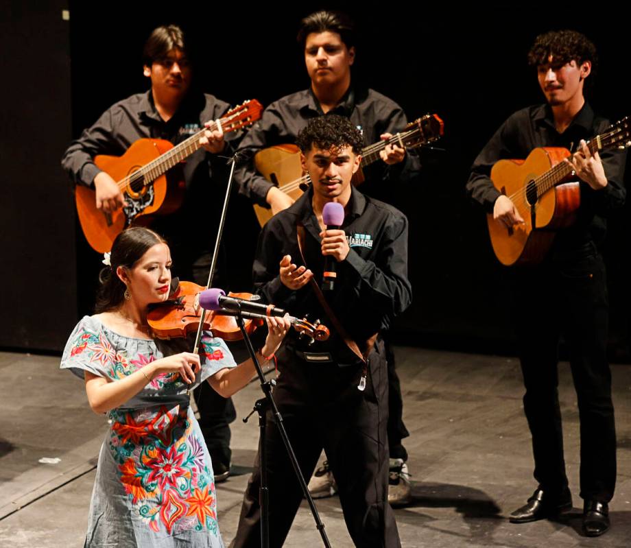Kevin A Aparicio Cabrera, center, sings as other members of the Las Vegas Academy of the Arts M ...