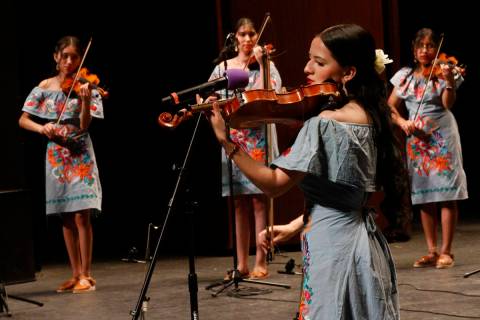 Haydee A Herrera, foreground, plays the violin with other members of the Las Vegas Academy of t ...