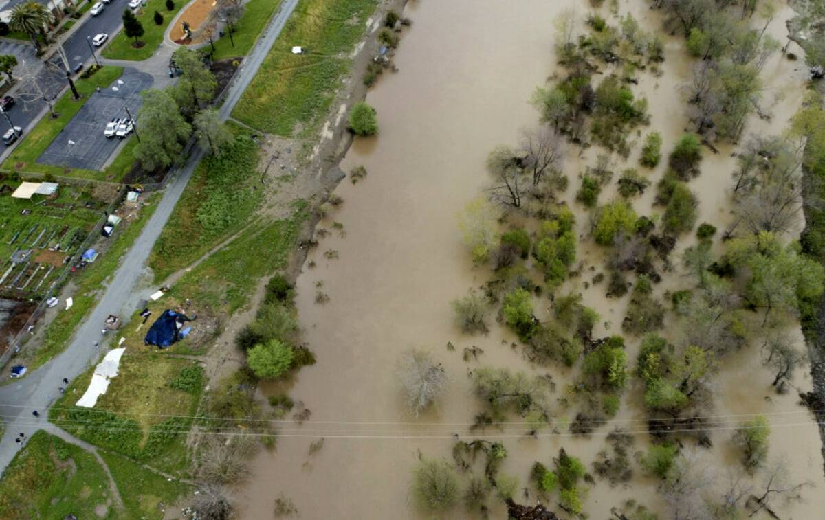 This photo shows a flooded Pajaro River in Pajaro, Calif. on Tuesday, March 14, 2023. (Californ ...