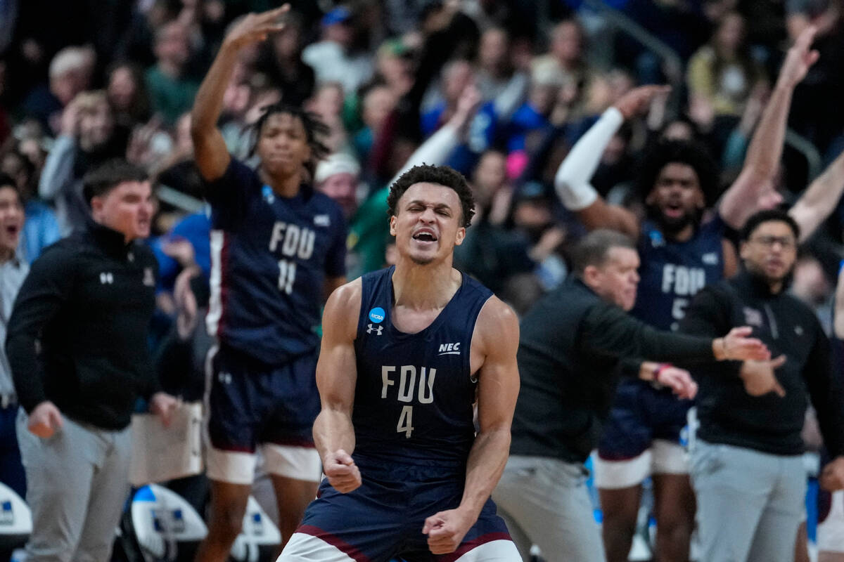 Fairleigh Dickinson guard Grant Singleton (4) celebrates after a basket against Purdue in the s ...