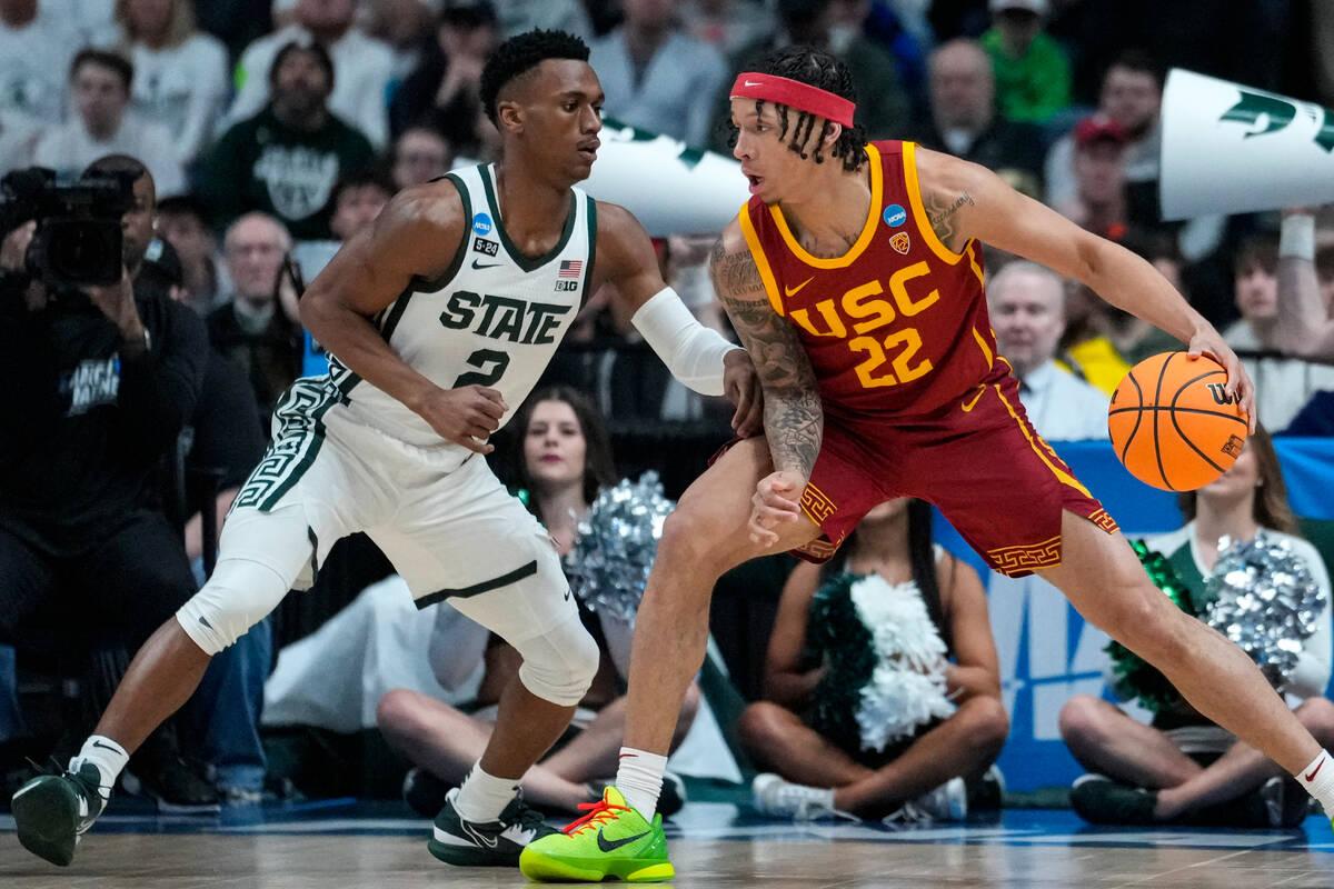 Southern California guard Tre White (22) drives on Michigan State guard Tyson Walker (2) in the ...