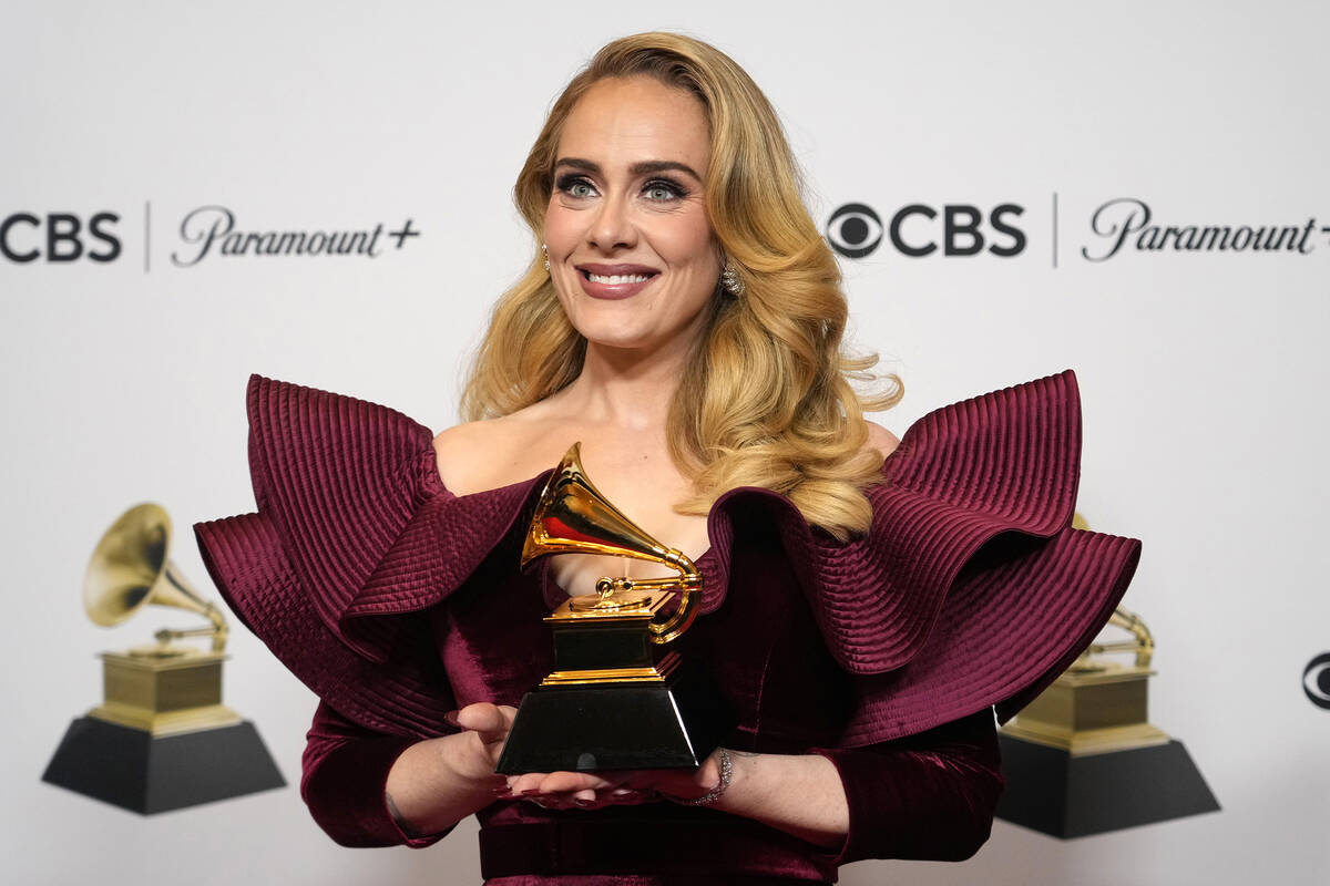 Adele, winner of the award for best pop solo performance for "Easy on Me," poses in t ...