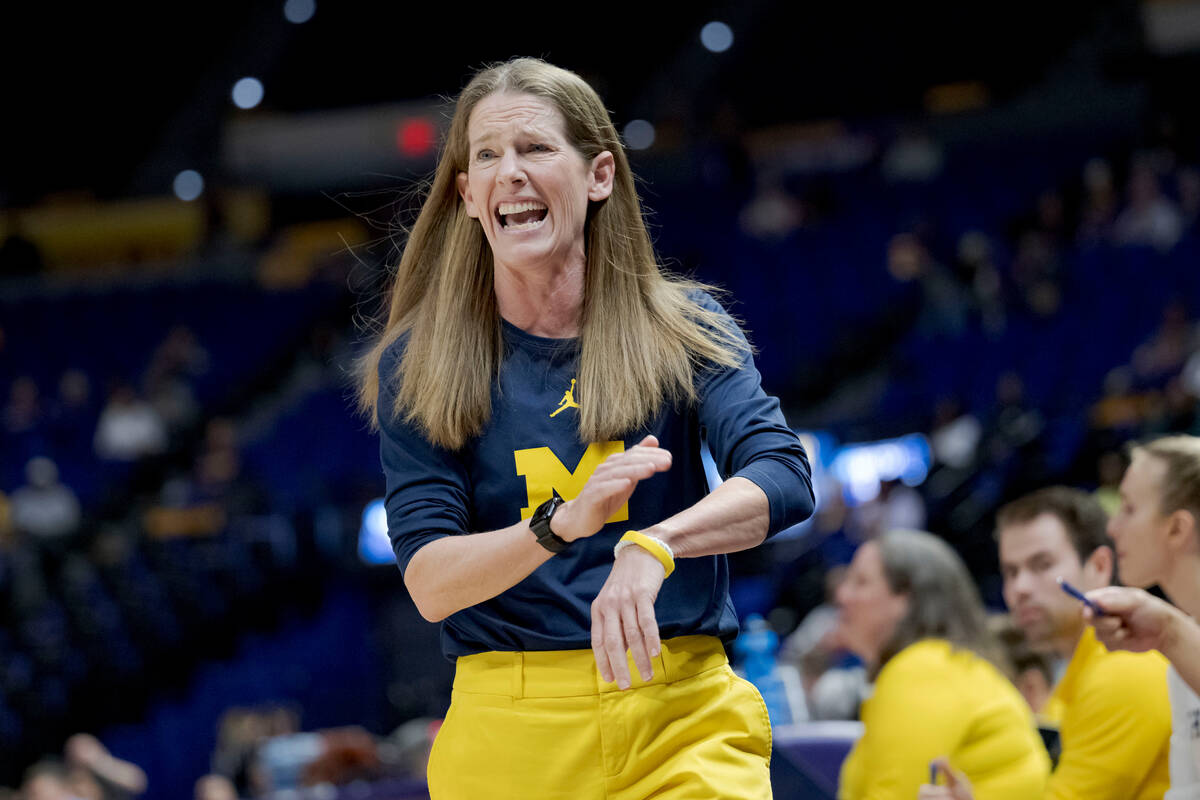 Michigan head coach Kim Barnes Arico reacts in the first half of a first-round college basketba ...