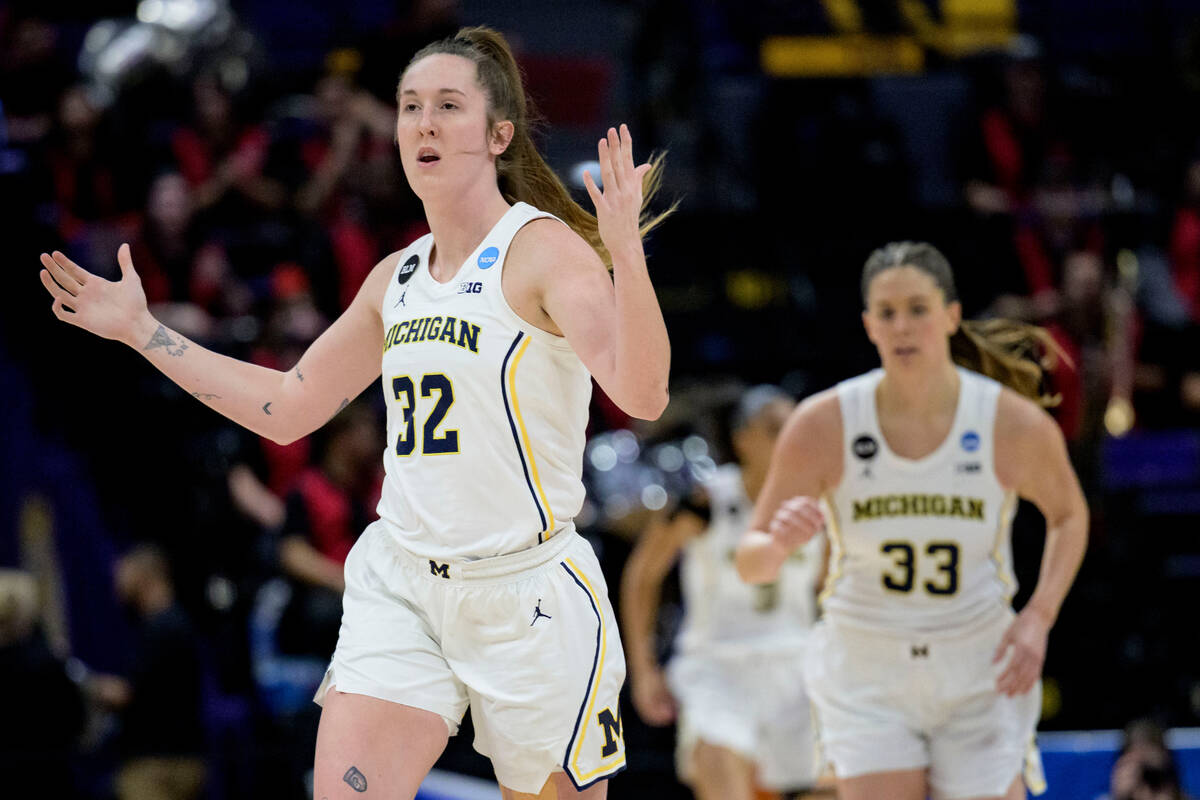 Michigan guard Leigha Brown (32) celebrates a 3-point basket by forward Emily Kiser (33) in the ...