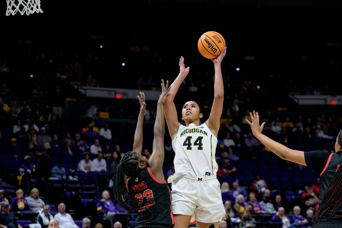 Michigan forward Cameron Williams (44) shoots against UNLV center Desi-Rae Young (23) in the se ...