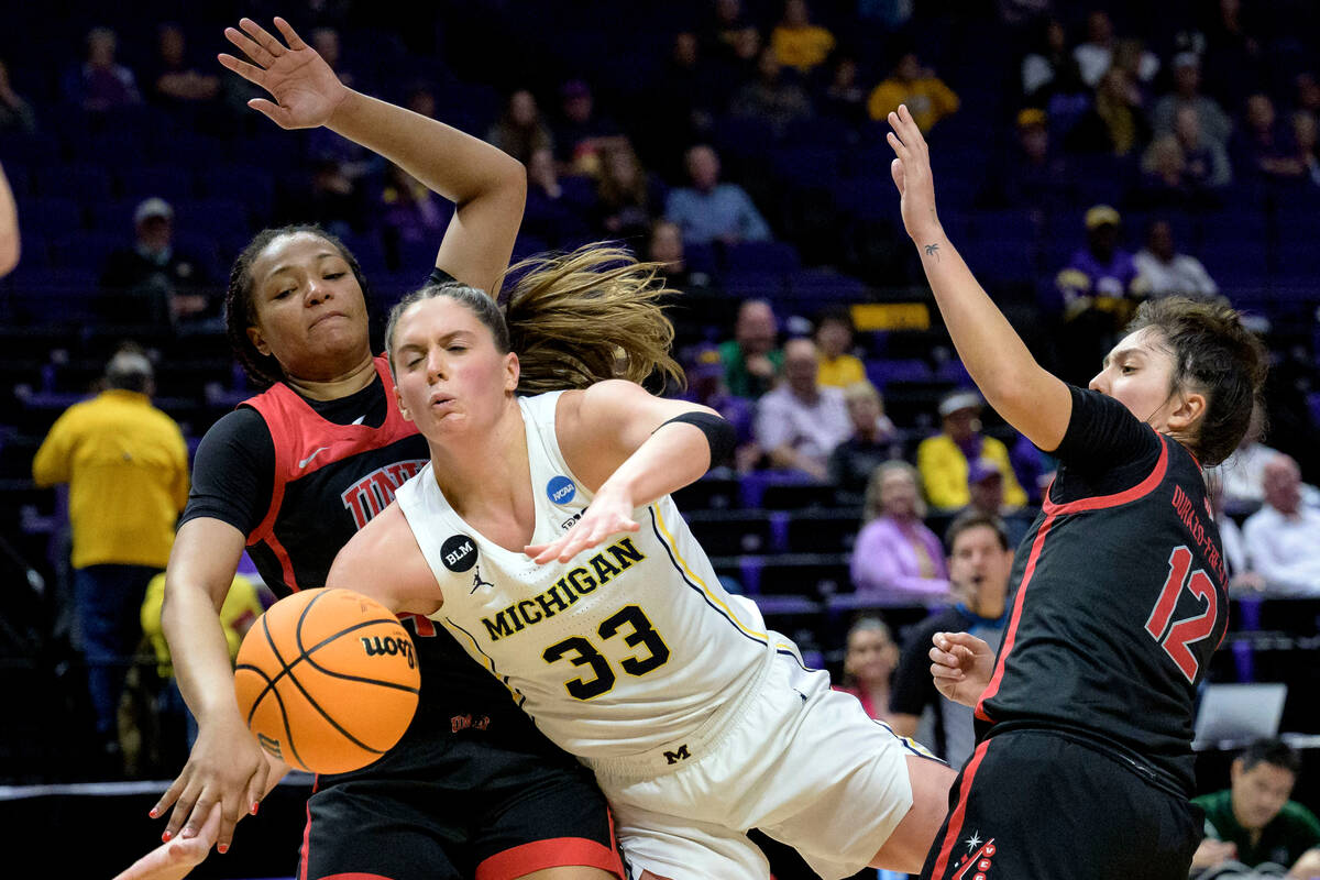 Michigan forward Emily Kiser (33) is fouled by UNLV forward Alyssa Brown (44) in the second hal ...