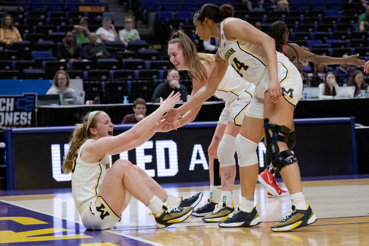 Michigan guard Elise Stuck, left, celebrates drawing a charge against UNLV in the first half of ...