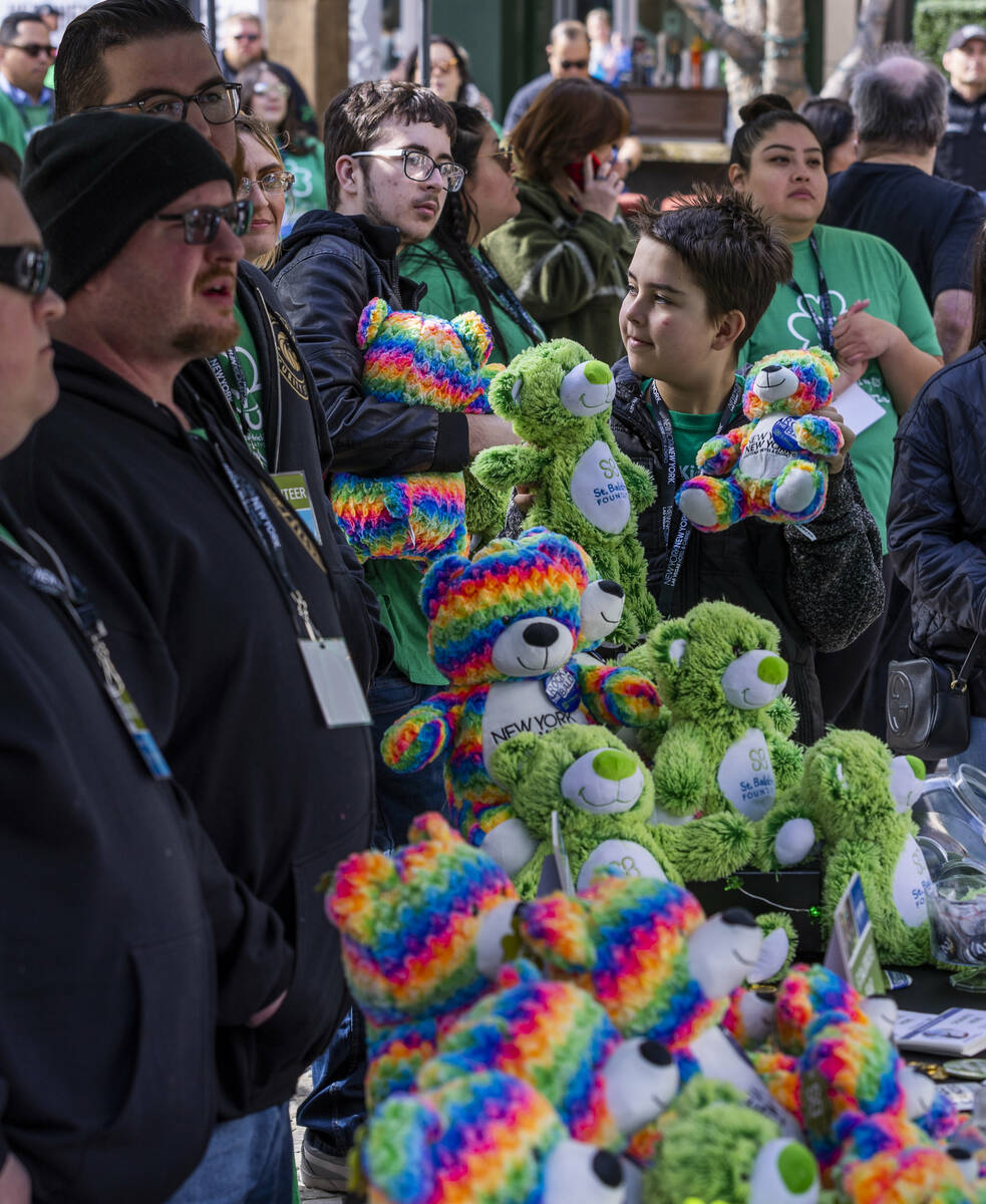 Mason Brooks, 12, shows off some stuffed bears which can be purchased as a donation during the ...