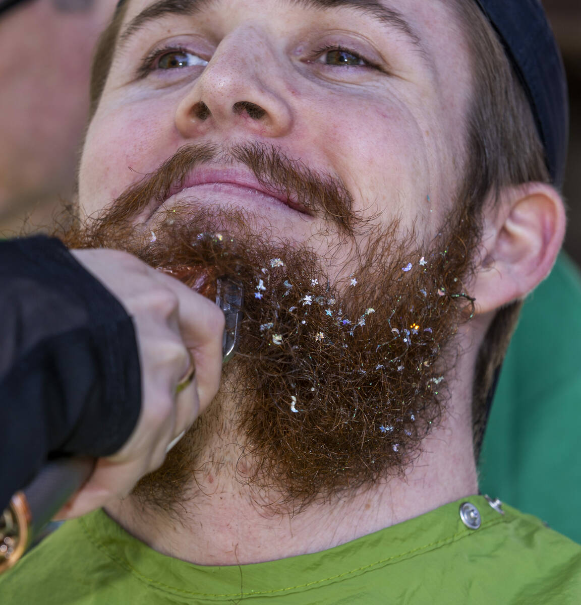 Fundraiser Colton West with MGM has his decorated beard shaved off by stylist Peyton LeBlue wit ...