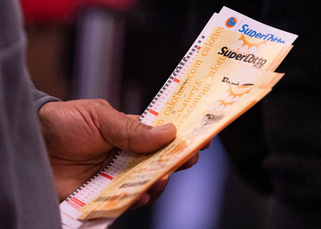 Regis Casillas of Las Vegas leaves the Lotto Store after buying lottery tickers at Primm, just ...
