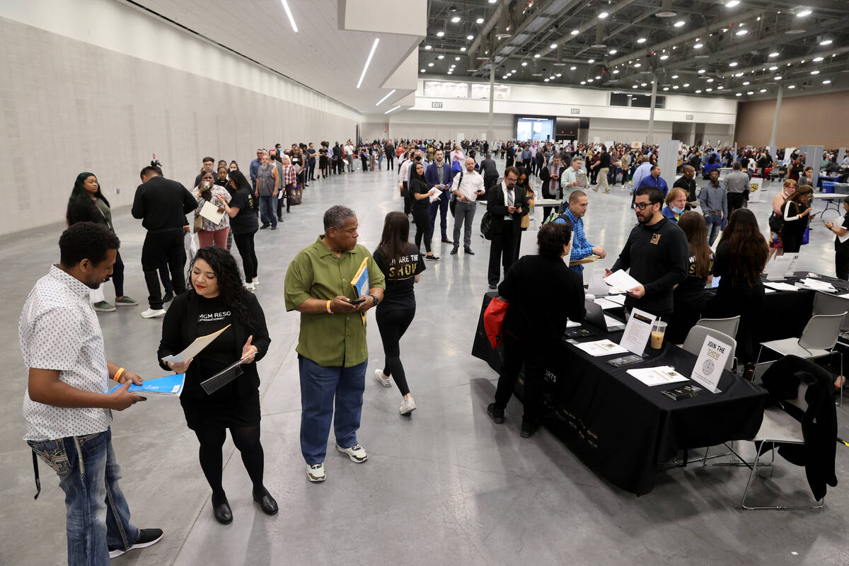Marison Campos, a recruiter with MGM Resorts International, talks to Abebe Yimer of Las Vegas d ...