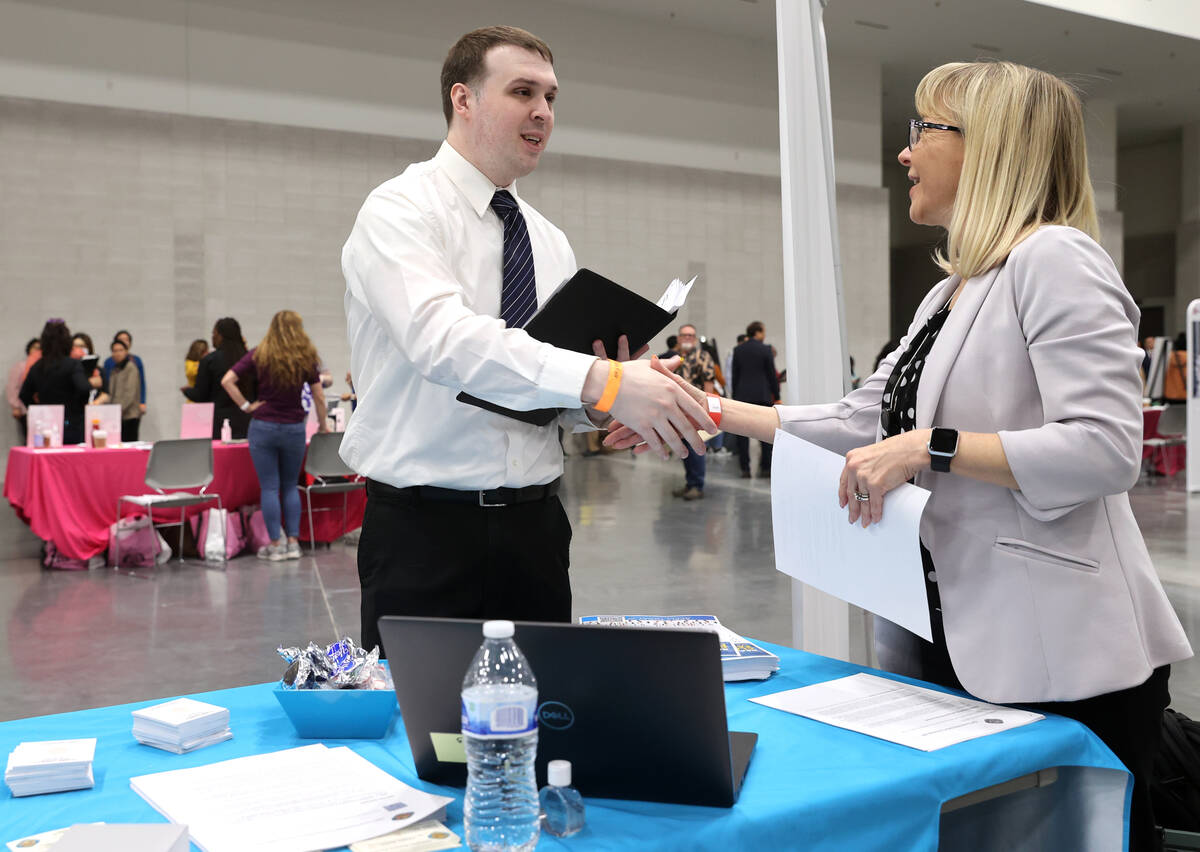 James Rodriguez talks to Dawn Reitz, senior human resources analyst with Clark County, during t ...