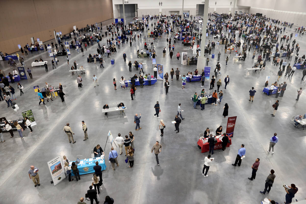 Job seekers visit booths during the Spring Job Fair at the Las Vegas Convention Center Friday, ...