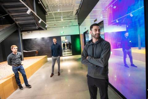 Mack Freedman, senior director of global real estate at DraftKings, right, leads a tour of Draf ...
