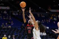 UNLV guard Justice Ethridge (11) shoots against Michigan guard Laila Phelia, right, in the firs ...
