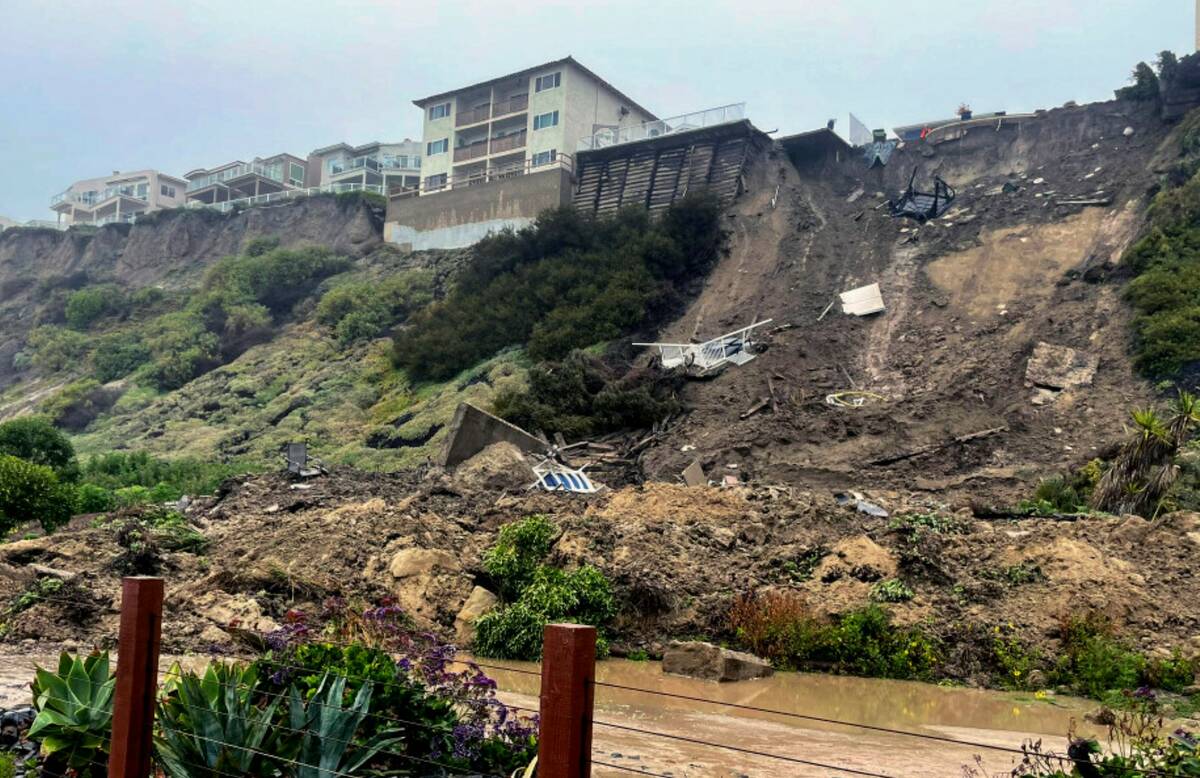Debris lines cliff where three apartment structures had to be evacuated due to a landslide in S ...