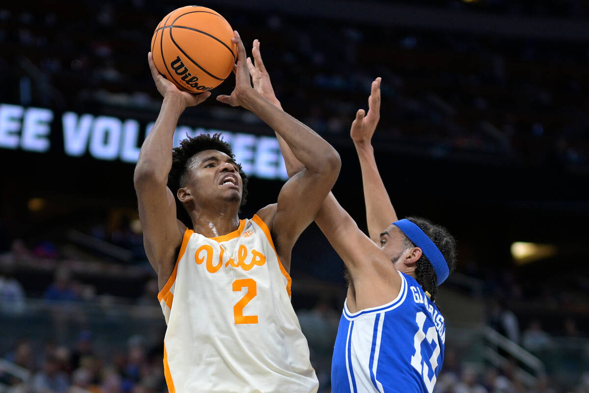 Tennessee forward Julian Phillips (2) shoots as Duke guard Jacob Grandison (13) defends during ...