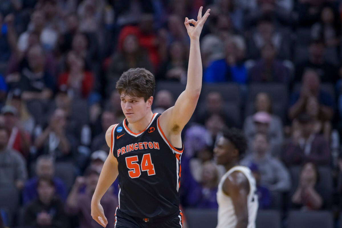 Princeton forward Zach Martini reacts after scoring on a 3-point shot during the first half of ...