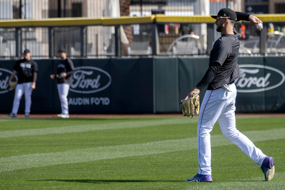 Kris Bryant of the Colorado Rockies throws during practice before an MLB exhibition game betwee ...