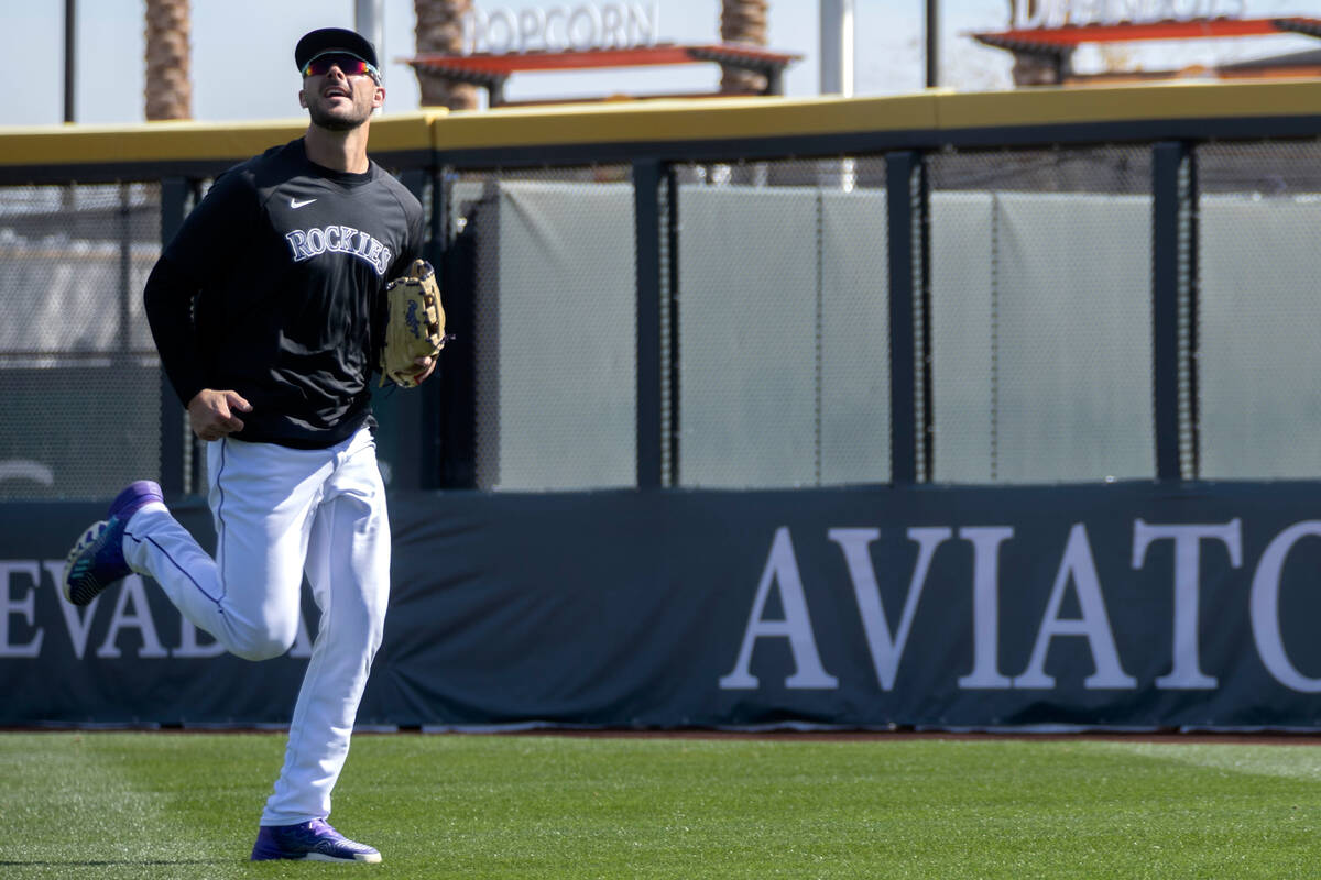 Kris Bryant of the Colorado Rockies runs to catch during practice before an MLB exhibition game ...