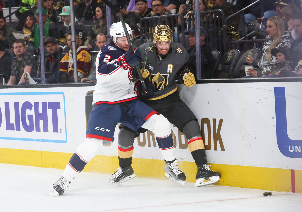 Columbus Blue Jackets defenseman Andrew Peeke (2) and Golden Knights right wing Reilly Smith ba ...