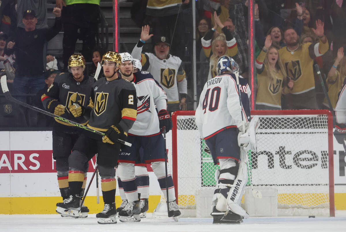Golden Knights defenseman Zach Whitecloud (2) reacts alongside Golden Knights center Brett Howd ...