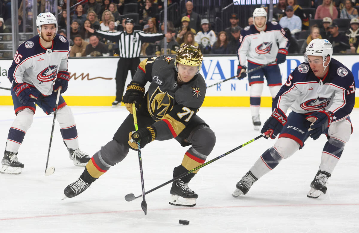 Golden Knights center William Karlsson (71) skates with the puck under pressure from Columbus B ...