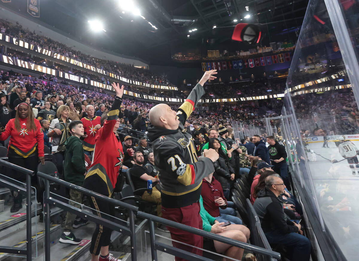Golden Knights fans throw hats onto the ice after center Jack Eichel, not pictured, landed a ha ...